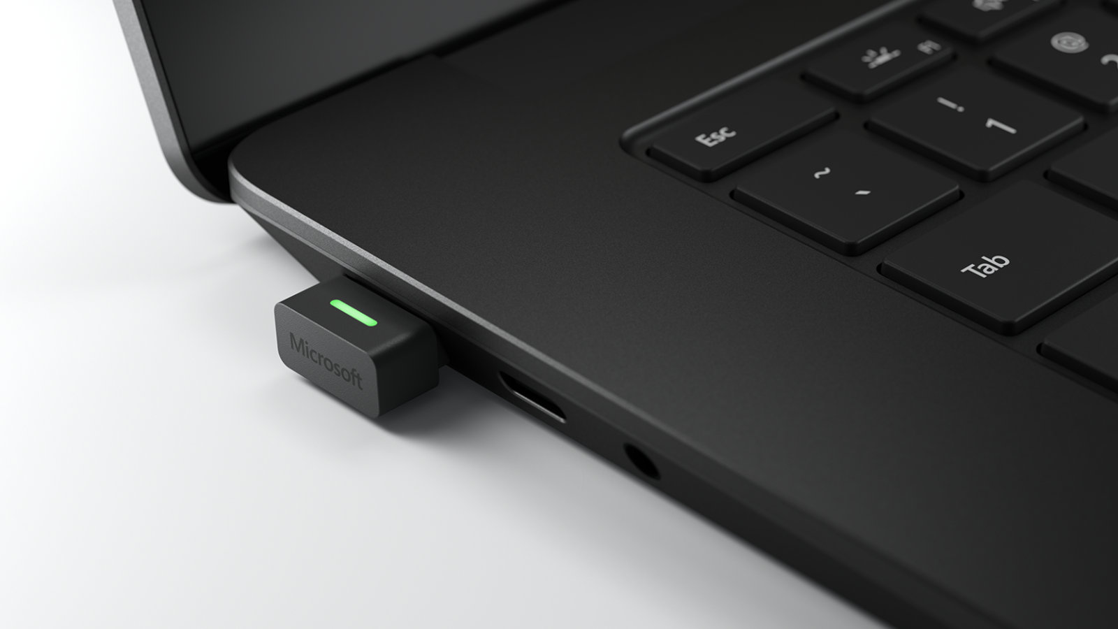 A close-up view of the USB Link connected to a Surface Pro 7+ device
