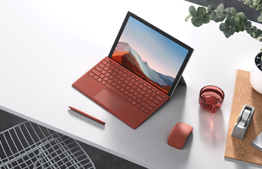 Top view of Surface Pro 7 plus and Surface Slim Pen 2 and mouse on a desk.