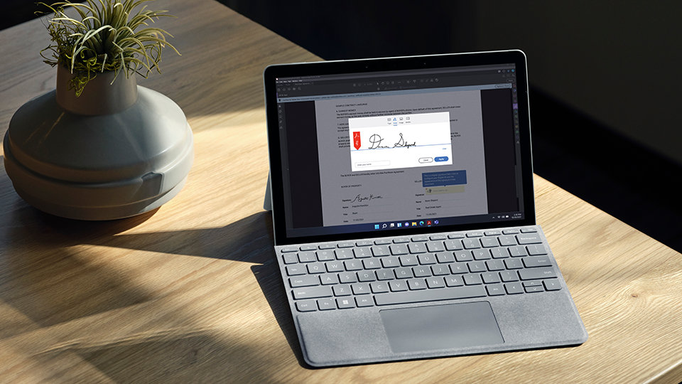 Surface Go 3 for Business on a desktop with a Type Cover attached.