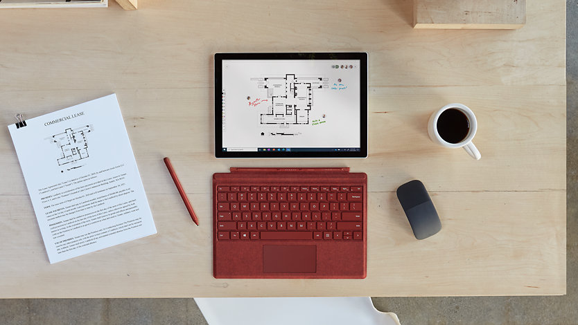 Surface Pro 7 plus flat on a table with keyboard detached, a mouse and a slim pen 2 nearby.