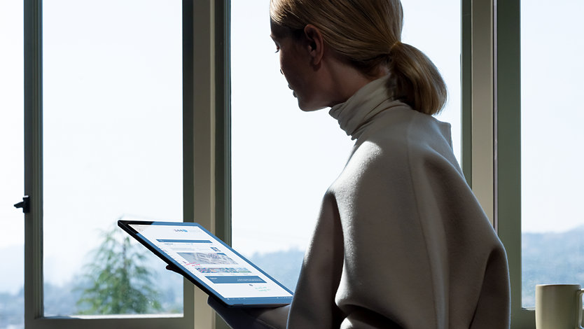 A person looking at Surface Pro 7+ for Business.