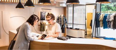 Two person's standing and looking at mobile.