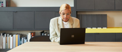 A person sitting at a desk using a computer