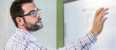 A person writing on a whiteboard