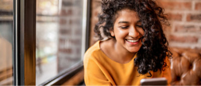 A girl smiling with curly hair