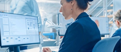 A woman looking at a computer screen.