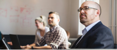 A group of people sitting in a conference room.