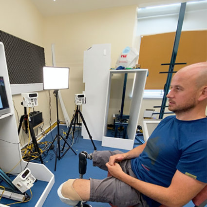 Man with bionic legs sitting down.