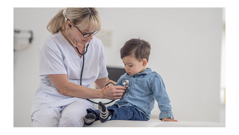 A healthcare working using a stereoscope on a child in a doctor's office