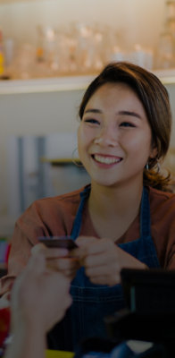 A person smiling while holding a phone