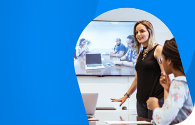 A person standing up and presenting in a meeting room.