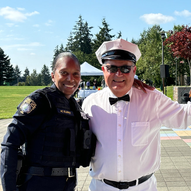 Officer smiling with ice cream vendor.