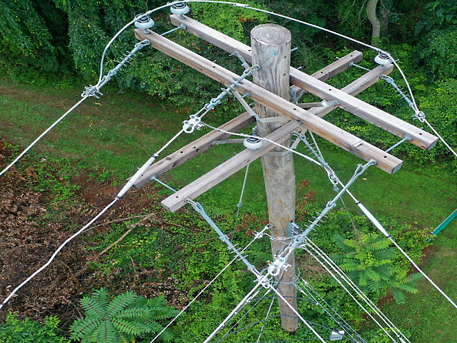 A wooden pole with wires attached