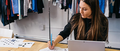 A woman sitting at a desk using a laptop.