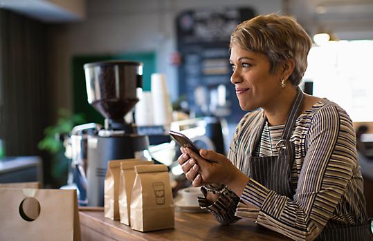 Woman on device at coffee shop