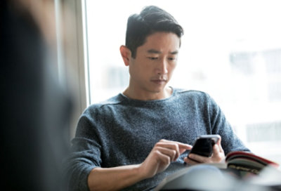a seated person using a mobile device