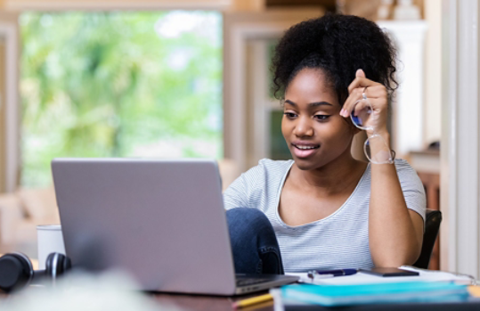 Photo credit: iStock/SDI Productions/Getty Images. Female college student uses laptop to study at home