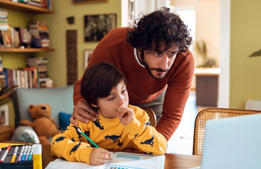 Photo credit: Marko Geber/DigitalVision/Getty Images. Father helping son with schoolwork at home