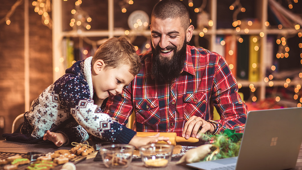 Smiling man and boy bake holiday desserts