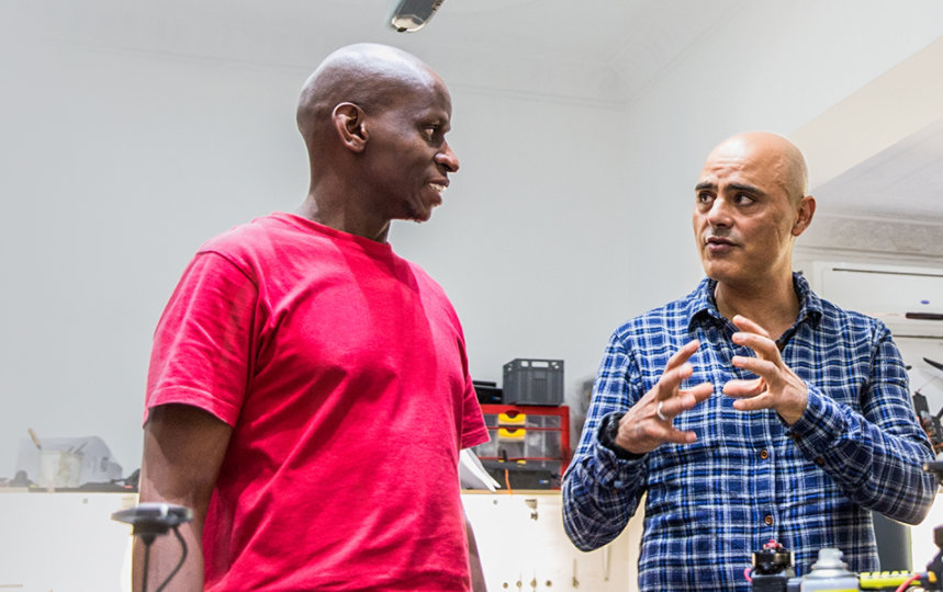  Two men working at a profit-for-purpose company in South Africa having a discussion.