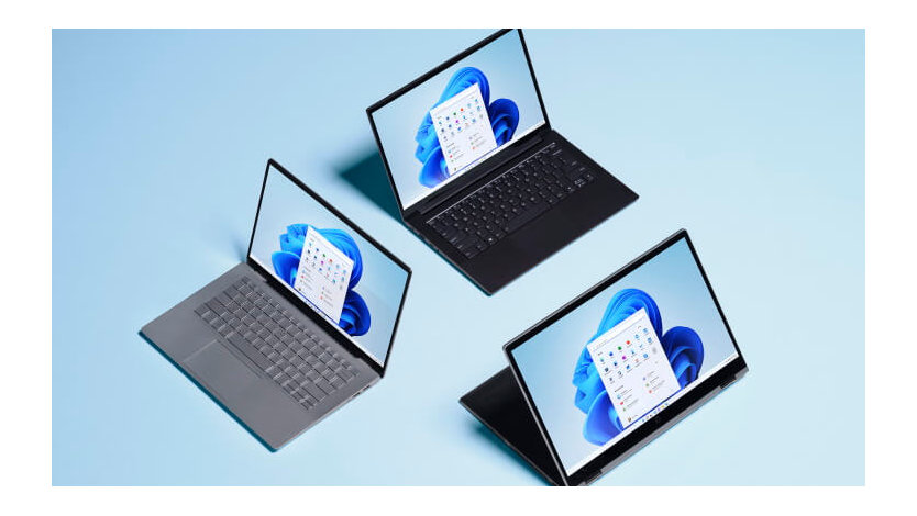 Three devices are arranged in a triangle with each showing a Windows 11 homepage.