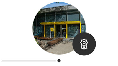 The outside entrance to the new Inclusive Tech Lab facility. There is a illustrated mural and a bright yellow awning. 