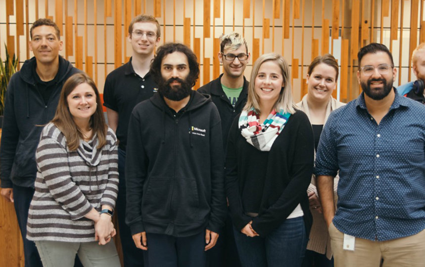 A small group of diverse people in the Supported Employment Program at Microsoft, smiling. 