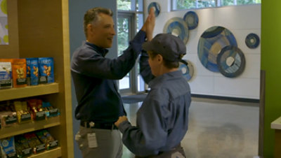 A manager and a café employee high-five
