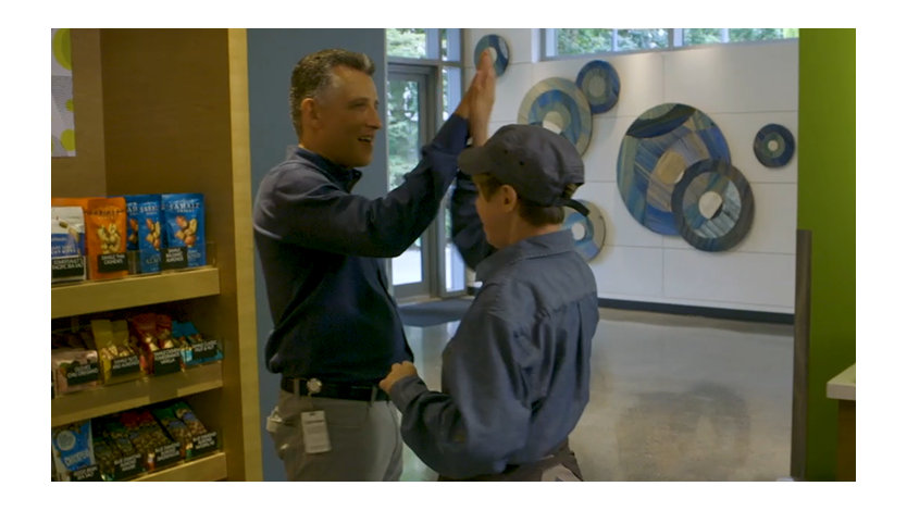 A manager and a café employee high-five