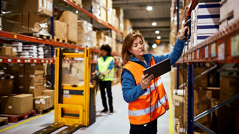 Women scanning inventory in warehouse