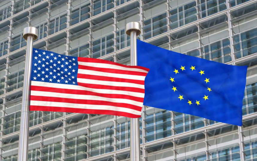 A photo of two flags: The United States of America and the European Union.