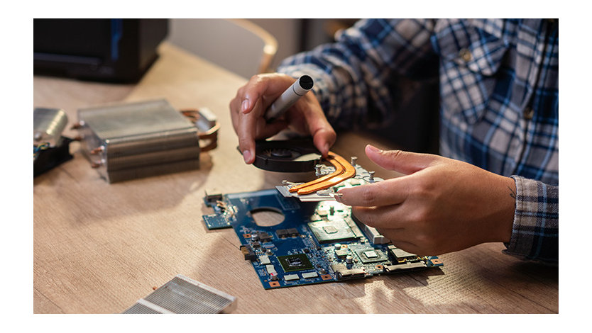 Man repairing/refurbishing a computer part.