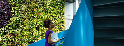 A female tech industry employee walks up a spiral staircase outside of U.S. office.