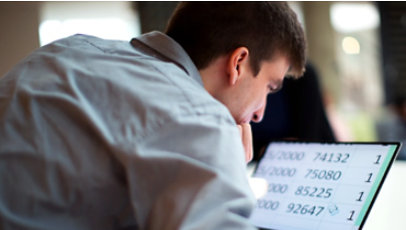 Man using magnification on a laptop screen.