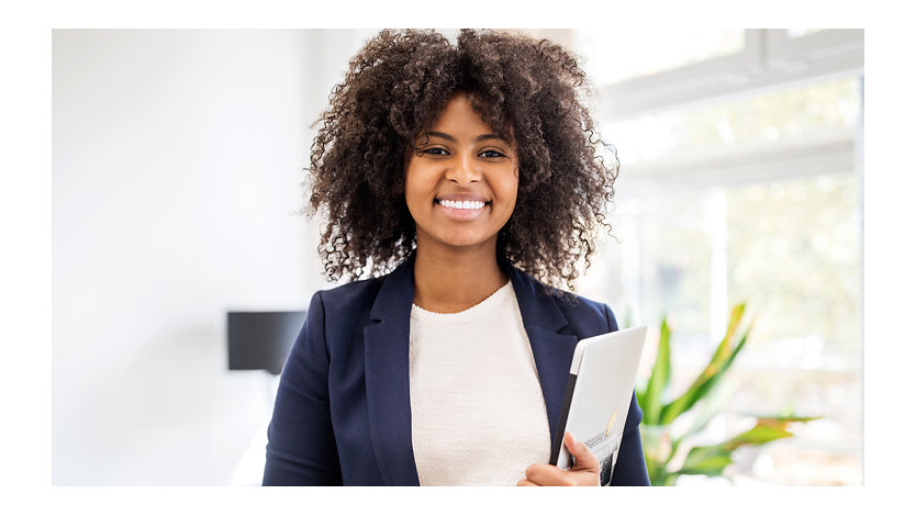 Portrait of confident businesswoman with laptop.