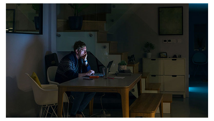 A person working late at night in a home office. 