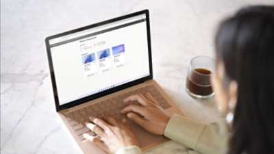 Osoba pisząca na laptopie z wyświetloną platformą Microsoft 365.