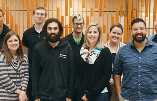 A small group of diverse people in the Supported Employment Program at Microsoft, smiling.