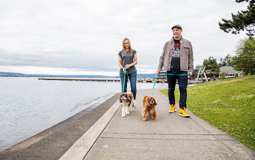 Craig Sincotta and a companion walk their dogs along a waterfront