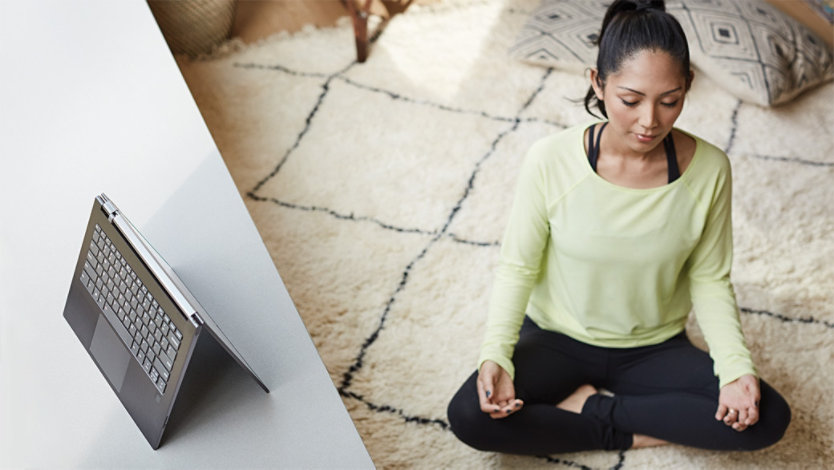 Woman sitting cross-legged meditating.