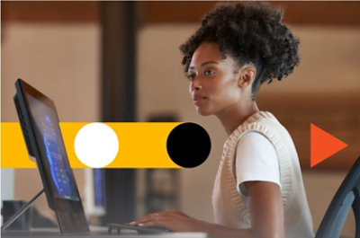 A person sitting in a chair using a laptop.