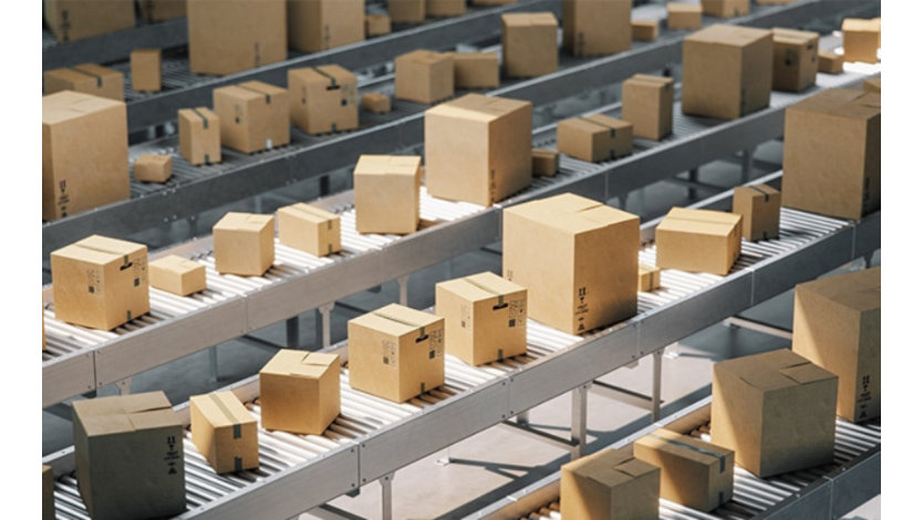 Cardboard boxes on conveyor belts in a distribution warehouse.
