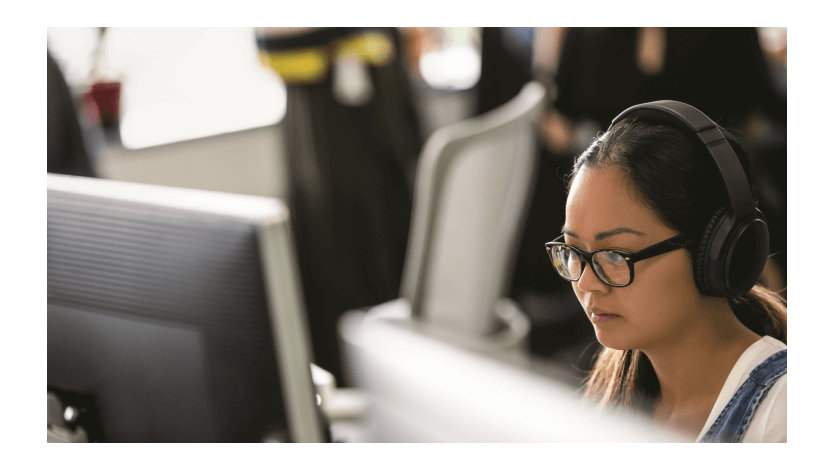 A Microsoft employee works at their desk. 