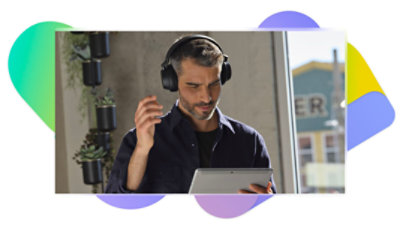 A person wearing a headset and using a tablet.