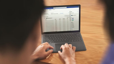 A silhouetted person is showing working on a Viva Topics dashboard.