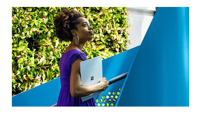 A female tech industry employee walks up a spiral staircase outside of U.S. office.