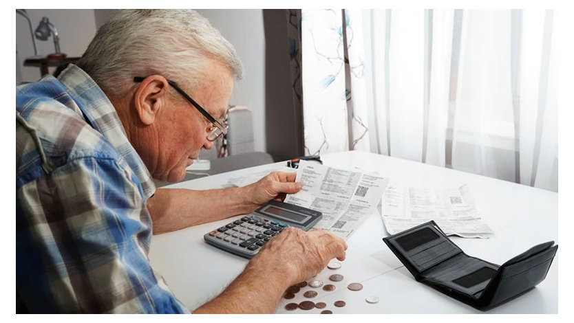 Person looking at a billing statement while using a calculator.