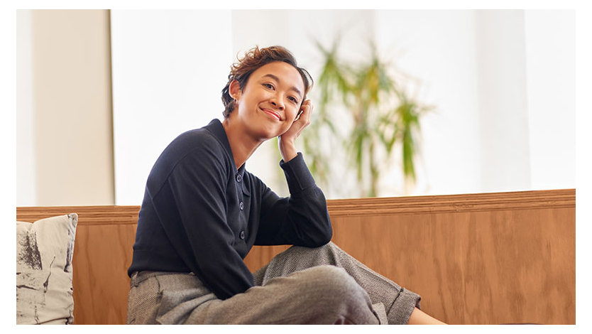 Smiling person relaxes in a home environment.