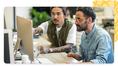 Two people looking at a monitor