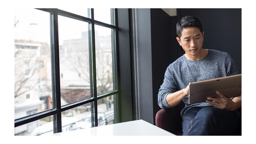 A Microsoft salesperson works on a laptop.